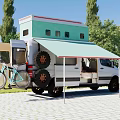 White Van With Green Rooftop Structure And Awning In Outdoor Setting With Trees And Grass