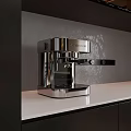 Stainless Steel Espresso Coffee Machine In Modern Kitchen With White Countertop And Grey Wall