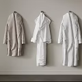 Hooks Hanging Beige White And Light Gray Robes On Light Gray Wall