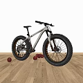 Fat Tire Mountain Bike with Large Wheels on Wooden Floor and Red Balls