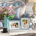 Light Blue Photo Frames with Women Photos Near Vase with Flowers and Gold Lamp