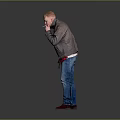 Man In Gray Jacket Blue Jeans And Red Shoes Standing Against Gray Background