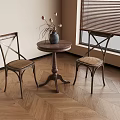 Classic Wooden Round Table with Cross Back Chairs and Vase on Herringbone Floor