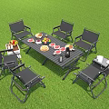 Outdoor Leisure Chairs On Green Grass With Table Featuring Fruits Bread And Drinks