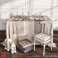Elegant Table and Chair Set with Linen Tablecloth Glassware Dinnerware Candles and Lanterns