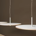 FLOS Round White Pendant Light Hanging Above Modern Table In Showroom Interior