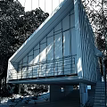 Modern Detached Villa With Large Glass Windows Sloped Roof And Green Tree Surroundings