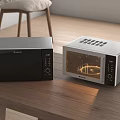 Modern Black and Silver Kitchen Appliances Microwave and Oven Placed on Wooden Table