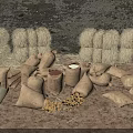 Hessian Storage Sacks Filled With Potatoes Near Hay Bales On Dirt Ground