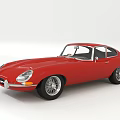 Red Classic Jaguar Sports Car With Sleek Body And Vintage Chrome Accents