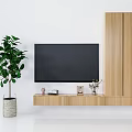 Wooden TV Stand With Mounted TV And Tall Cabinet Decorated With Plant And Ornaments