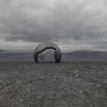 Mysterious Commercial Landscape With Large Arched Structure Barren Ground And Gray Sky