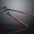 Professional Hardware Tool Pliers with Metal Jaws and Red Handles on Dark Background