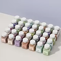 Decorative Ornament Set Featuring Small Bottles with White Caps and Various Colored Powders Neatly Arranged