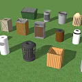 Public Trash Bins With Various Colors And Different Shapes In Green Grassy Area