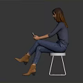 Woman Sitting On White Chair In Gray Top Blue Jeans Holding Phone Against Gray Background