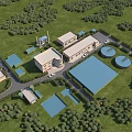 Industrial Plant Complex With Circular Storage Tanks And Green Grass Trees Surroundings