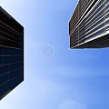 Tall Modern Office Building Exterior Design With Glass Curtain Walls And Blue Sky