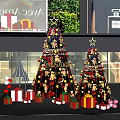 Festive Christmas Trees With Decorations And Gift Boxes In Store