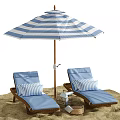 Blue Wicker Lounge Chairs With Striped Pillows Under Beach Umbrella On Sand