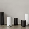 Public Facility Waste Bins Various Sizes Black And White Cylindrical Against Gray Wall On Floor