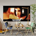 Wooden Table And Chair Set With Projector Screen White Tent String Lights And Green Plants