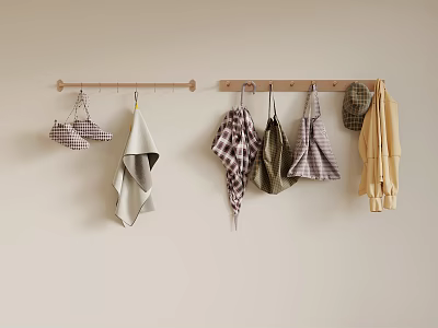 Various Kitchen Aprons And Towels Hanging On Wooden Hooks Against Beige Wall 3d model