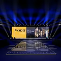 Grand voco Hotel Launch Event Stage With Backdrop Screen Architectural Images And Blue Lighting