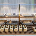 Freshly Baked Bread and Pastries Displayed on Wooden Shelves with Assorted Loaves Rolls and Treats