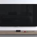 Wall Mounted TV on White Wall with Wooden Shelf Black Device and Red Rose