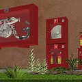 Red Fire Equipment Setup With Fire Box Hose Cabinet Extinguishers And Green Plants On Grass