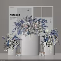 Elegant Modern Floral Display with Blue White Blooms in White Cylindrical Vessels and Small Candles