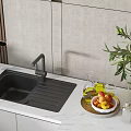 Black Modern Kitchen Sink on White Countertop with Fruit Bowl Olive Plant and Oil Bottles