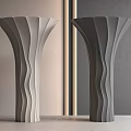 Two Unique Columns with Light Dark Gray Wavy Texture Against Gray Wall Vertical Light Strip