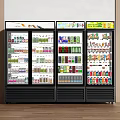 Commercial Display Refrigerators With Glass Doors Stocked Full Of Assorted Beverages In Retail Shop
