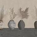 Textured Ceramic Vases With Dried Pampas Grass On Textured Table Against Light Wall