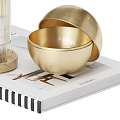 Decorative Ornament Set With Transparent Glass Cup Wooden Base And Golden Bowls On Magazine