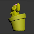Green Cactus With Black Eyes Sticking Out Tongue And Pink Flower In Brown Clay Pot