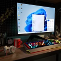 Modern Computer Monitor Desktop Setup With RGB Backlit Keyboard Headphones And Desk Accessories