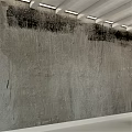 Concrete Sphere Component With Cracked Surface Against Textured Gray Wall With Black Stains