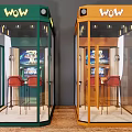 Musical Instruments And Art Supplies Display In Green And Orange Glass Enclosures With Red Chairs