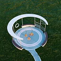 Children's Play Area With Circular Canopy Swings Green Grass And Pathway