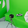 Green Screen Studio Setup with Studio Lights Umbrellas Camera Tripod and Toy Car