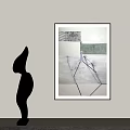Abstract Black Sculpture Art On Gray Wall With Framed Painting And Soft Lighting