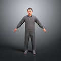 Man in Gray Hoodie and Gray Pants Standing with Arms Outstretched on Gray Background