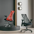 Two Red And Black Ergonomic Office Chairs With Mesh Design On Display Stand