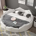 Round White Double Bed in Bedroom with Gray Wall Framed Pictures and Pendant Lights