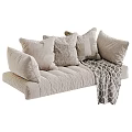 Cozy Neutral Sofa Decor With Multiple Soft Textured Pillows And Knitted Blanket