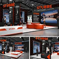 STUBBE Exhibition Booth Design With Orange And Black Display Area Reception Desk And People