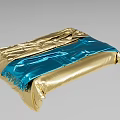 Gold And Blue Foil Wrapped Object With Wrinkles And Fringe Details